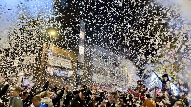 Confetti cannons fill the air with snowflake confetti at Christmas Lights Switch-On event